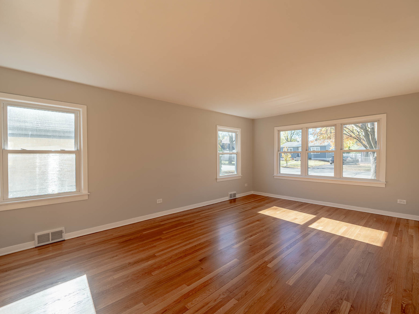 805 Spring Road Elmhurst, IL 60126 - Photo 2 of 16 a view of an empty room with wooden floor and a window
