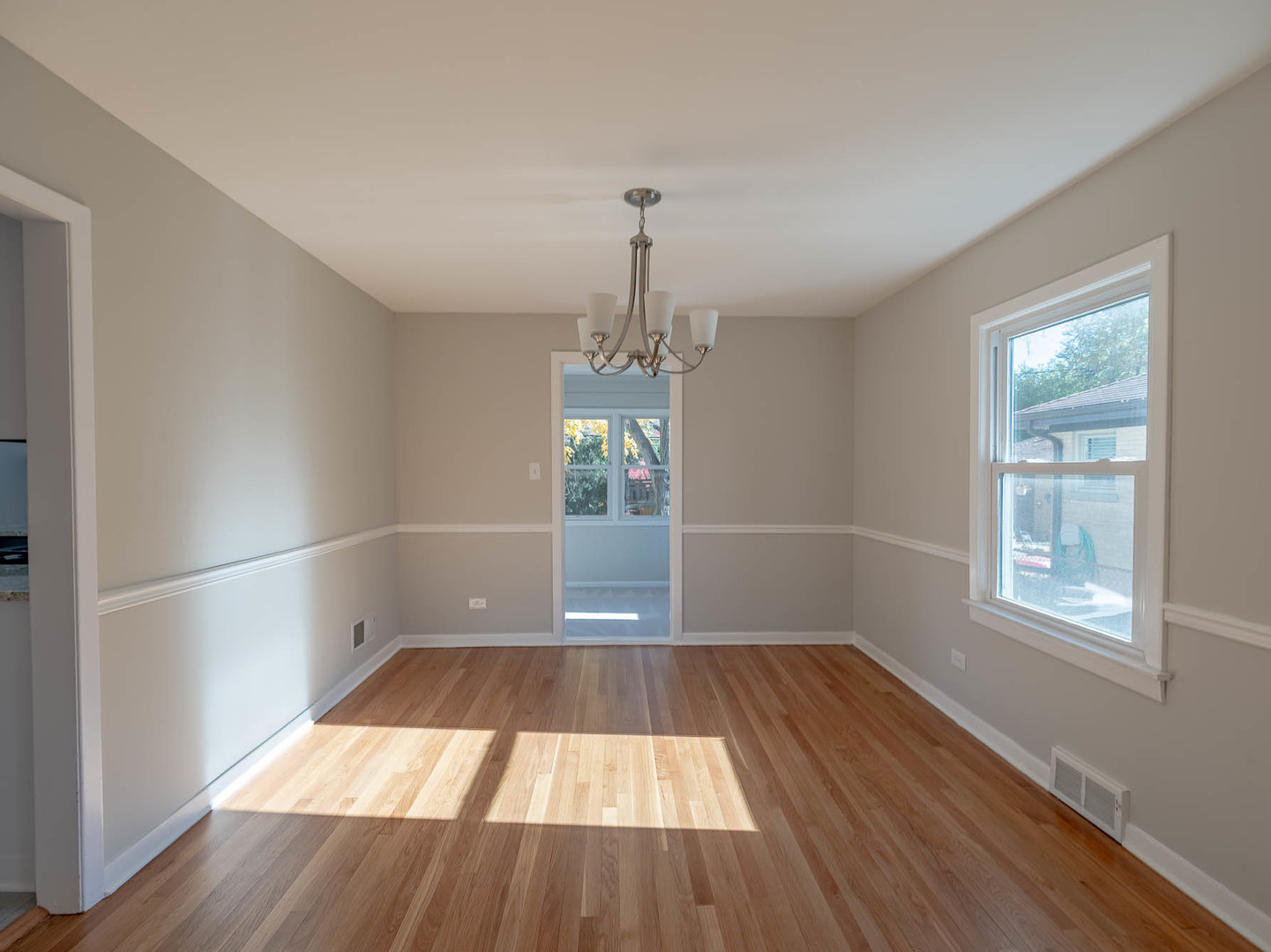 805 Spring Road Elmhurst, IL 60126 - Photo 3 of 16 wooden floor in an empty room with a window