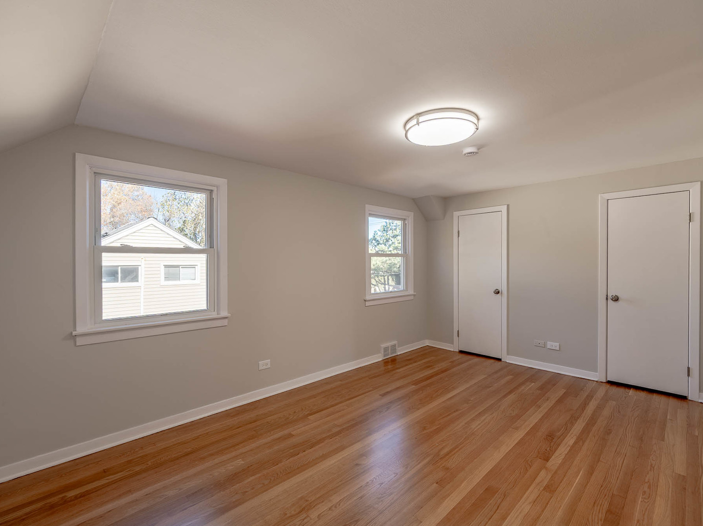 805 Spring Road Elmhurst, IL 60126 - Photo 8 of 16 a view of an empty room with wooden floor and a window