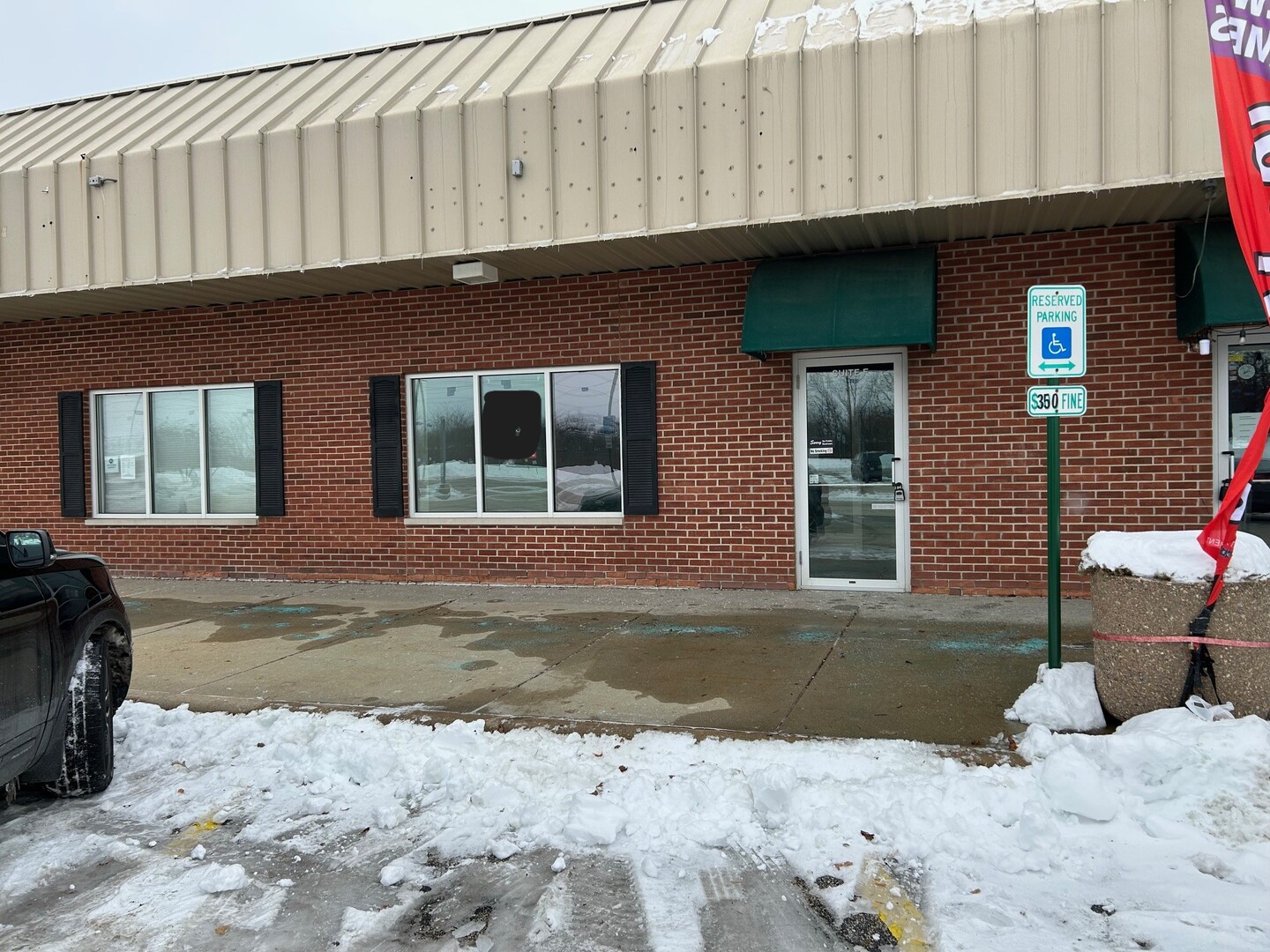 a front view of a building with outdoor space