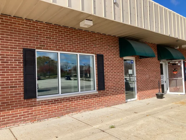 a view of a brick house with large windows