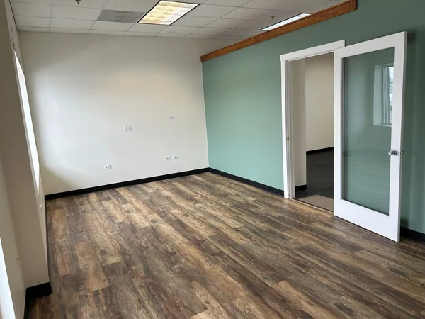 an empty room with wooden floor and closet
