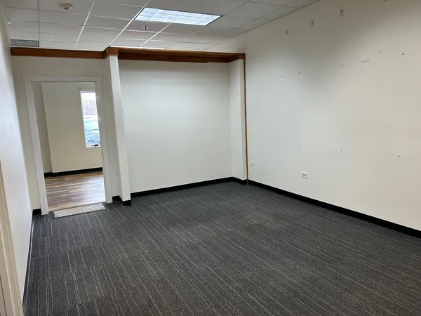 an empty room with wooden floor and closet
