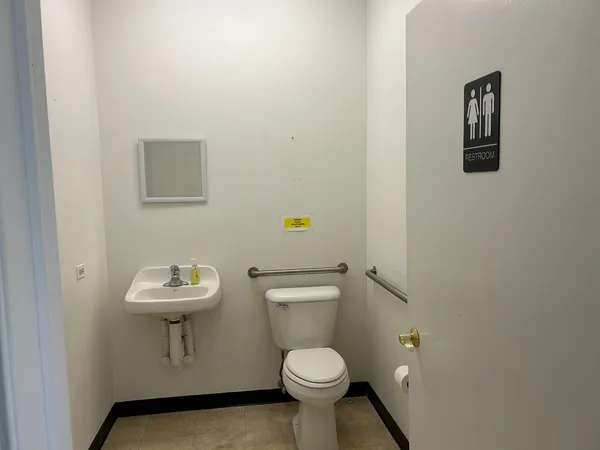 a white toilet sitting next to a bathroom sink