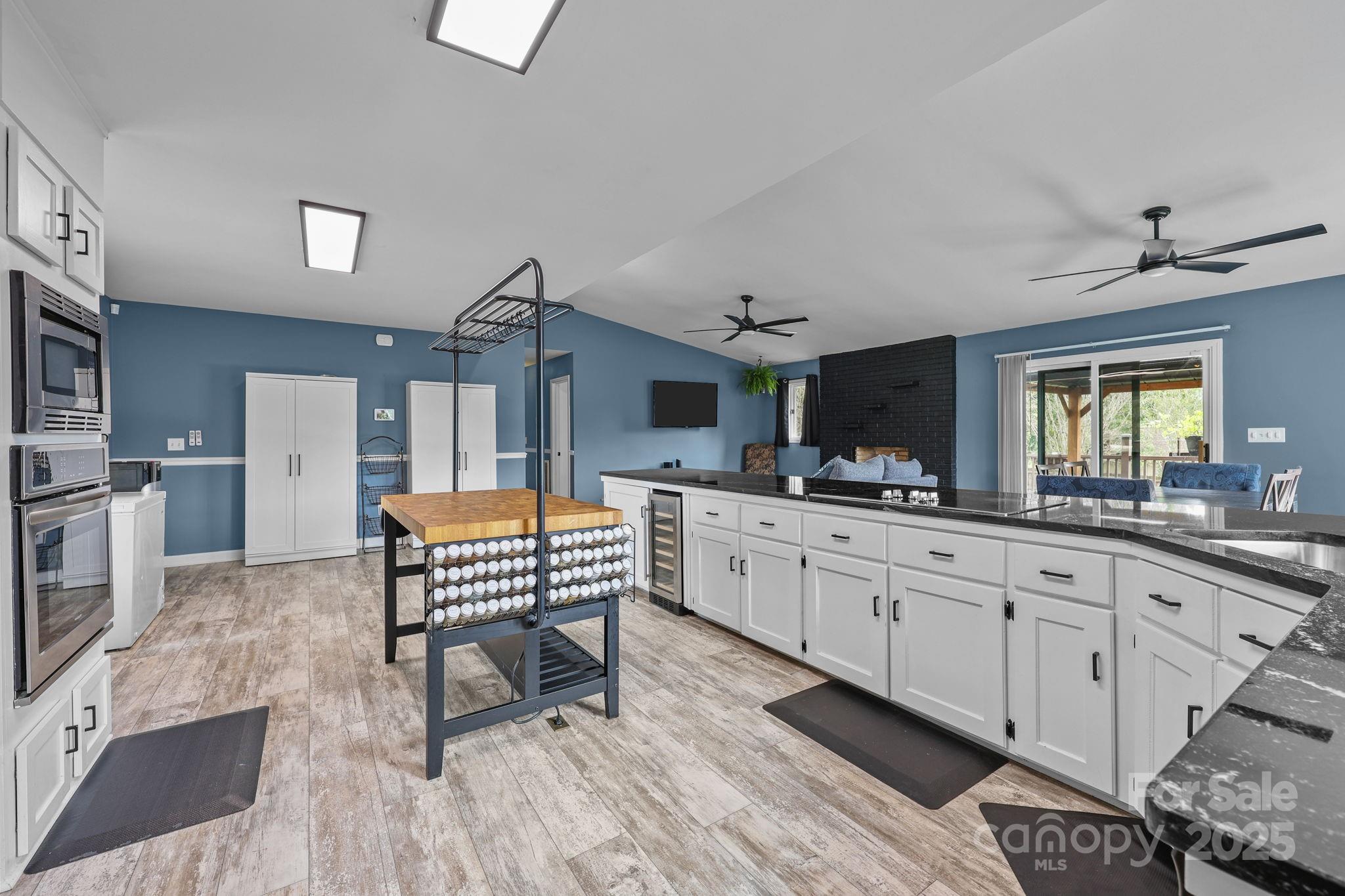 a open kitchen with sink cabinets and wooden floor