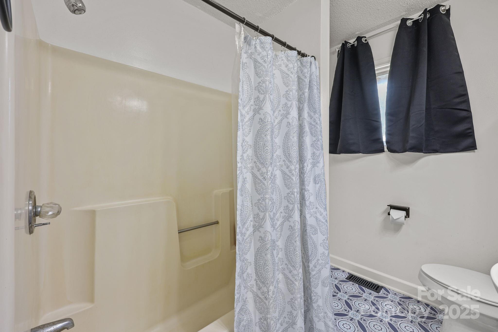 1765 Liberty Road Gold Hill, NC 28071 - Photo 21 of 41 a bathroom with a shower and a toilet