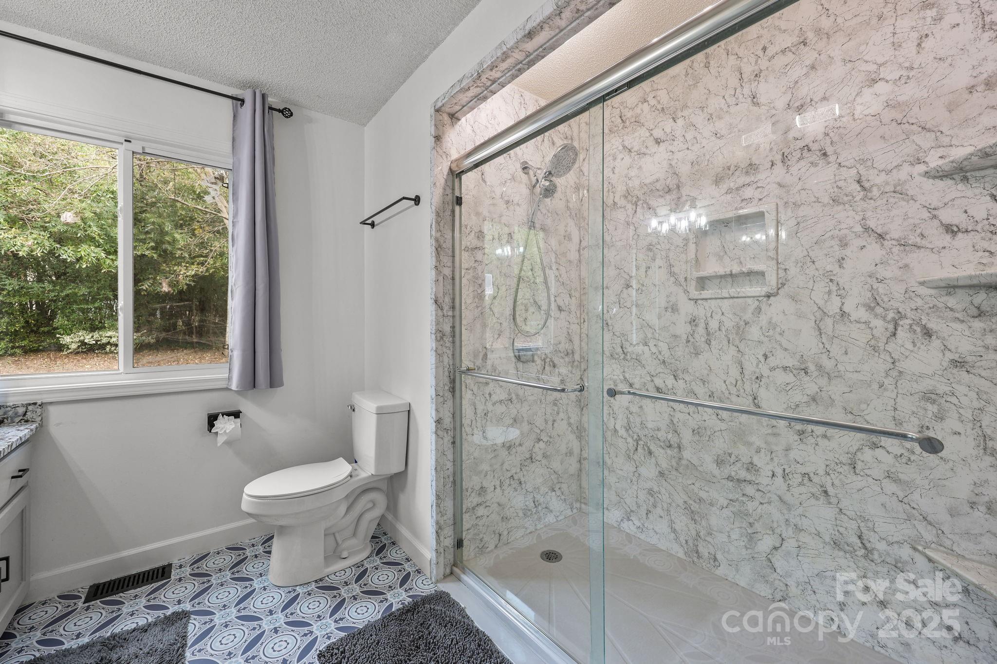 1765 Liberty Road Gold Hill, NC 28071 - Photo 25 of 41 a bathroom with a shower toilet and sink