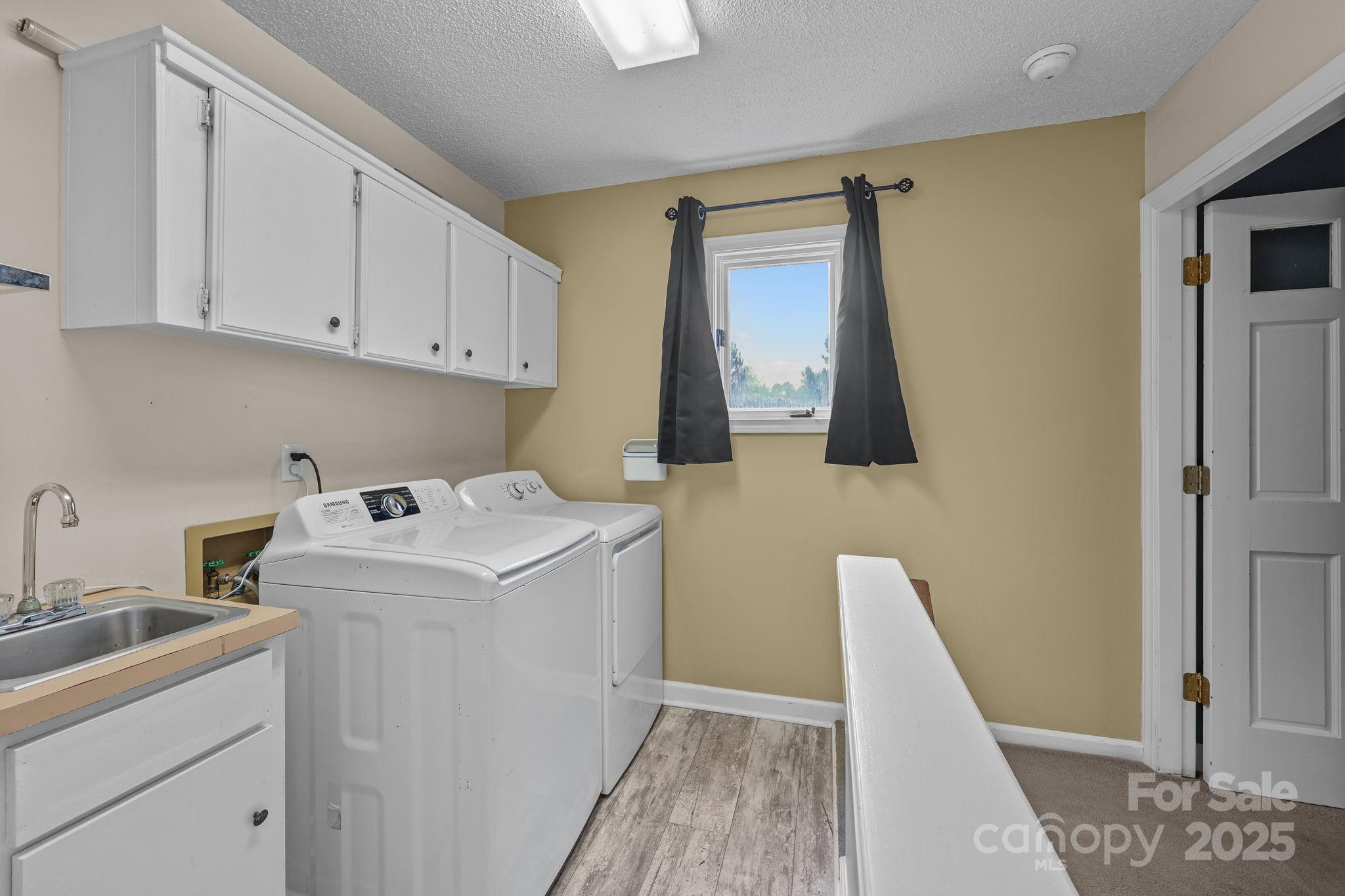 1765 Liberty Road Gold Hill, NC 28071 - Photo 27 of 41 a utility room with sink dryer and washer