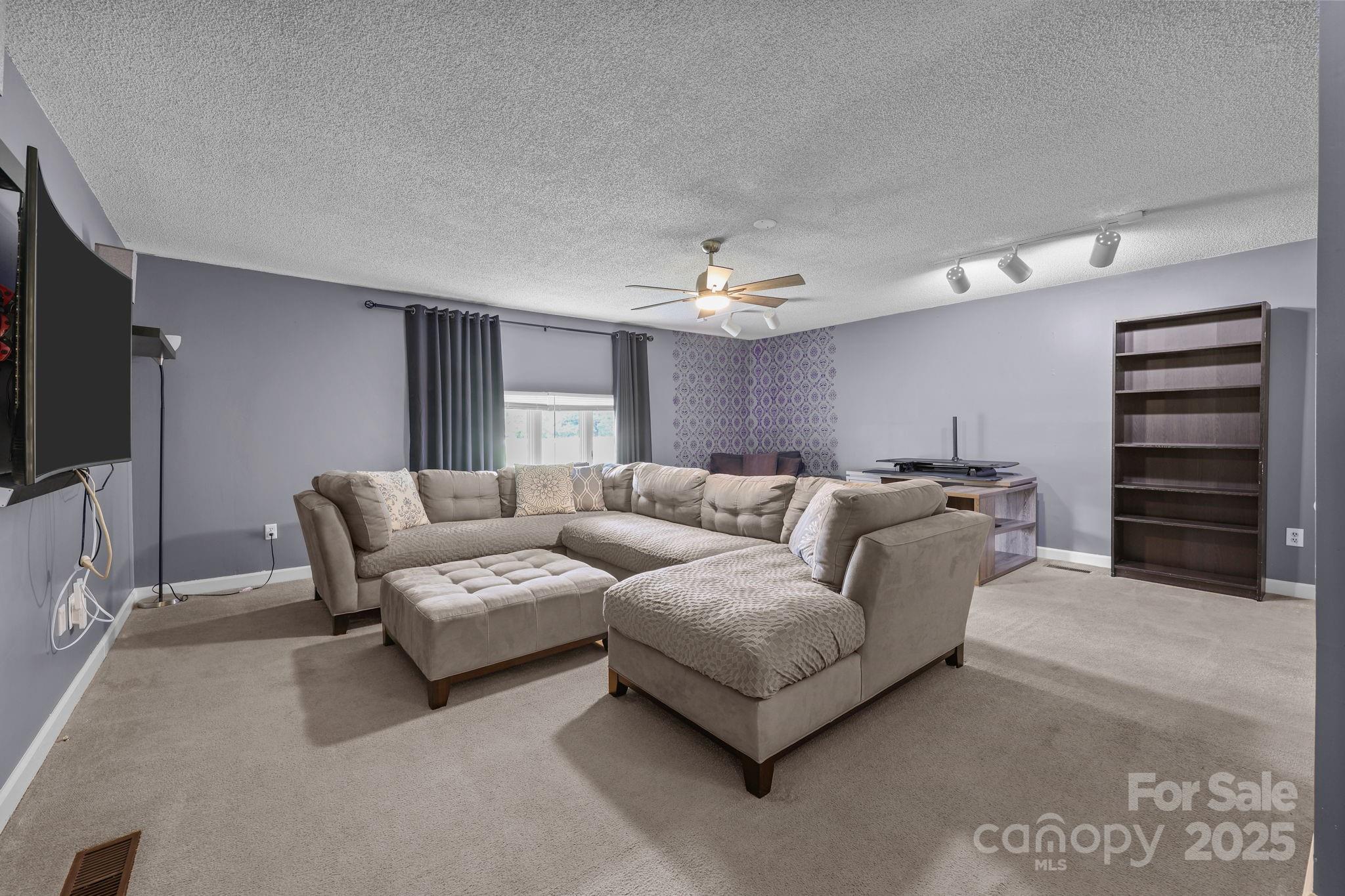 1765 Liberty Road Gold Hill, NC 28071 - Photo 28 of 41 a living room with furniture and a flat screen tv