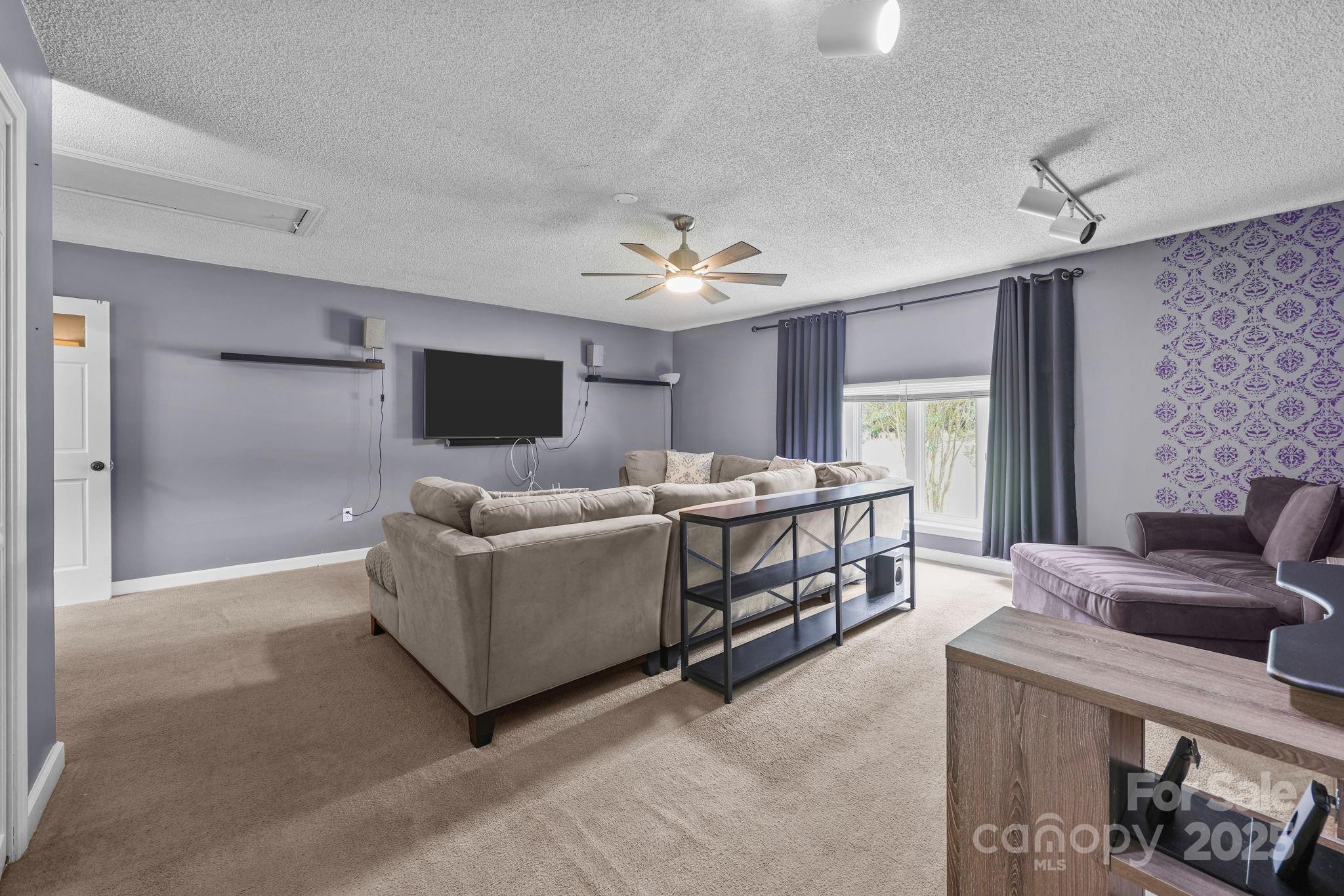 1765 Liberty Road Gold Hill, NC 28071 - Photo 30 of 41 a living room with furniture and a flat screen tv