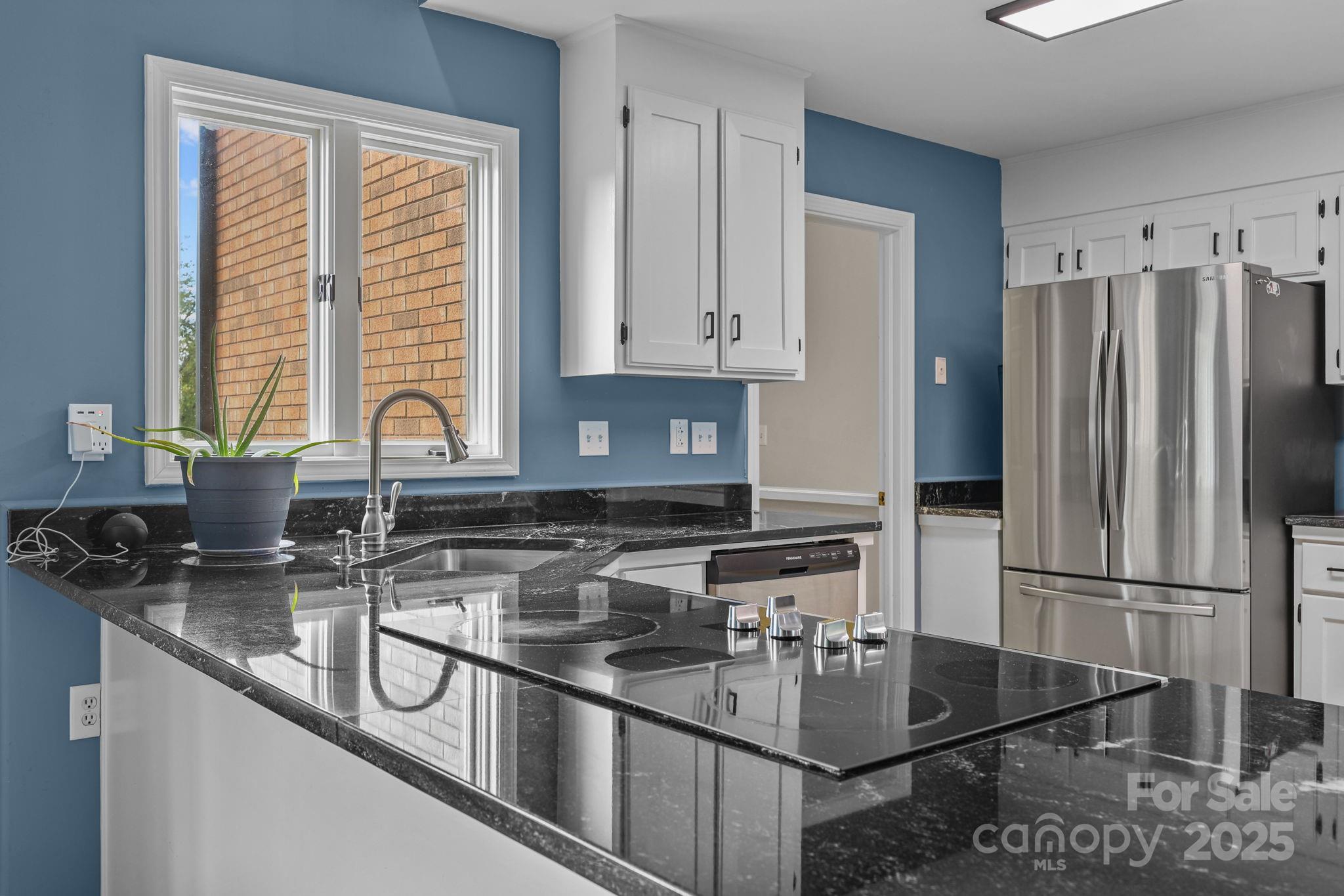 1765 Liberty Road Gold Hill, NC 28071 - Photo 5 of 41 a kitchen with stainless steel appliances granite countertop a sink stove and refrigerator
