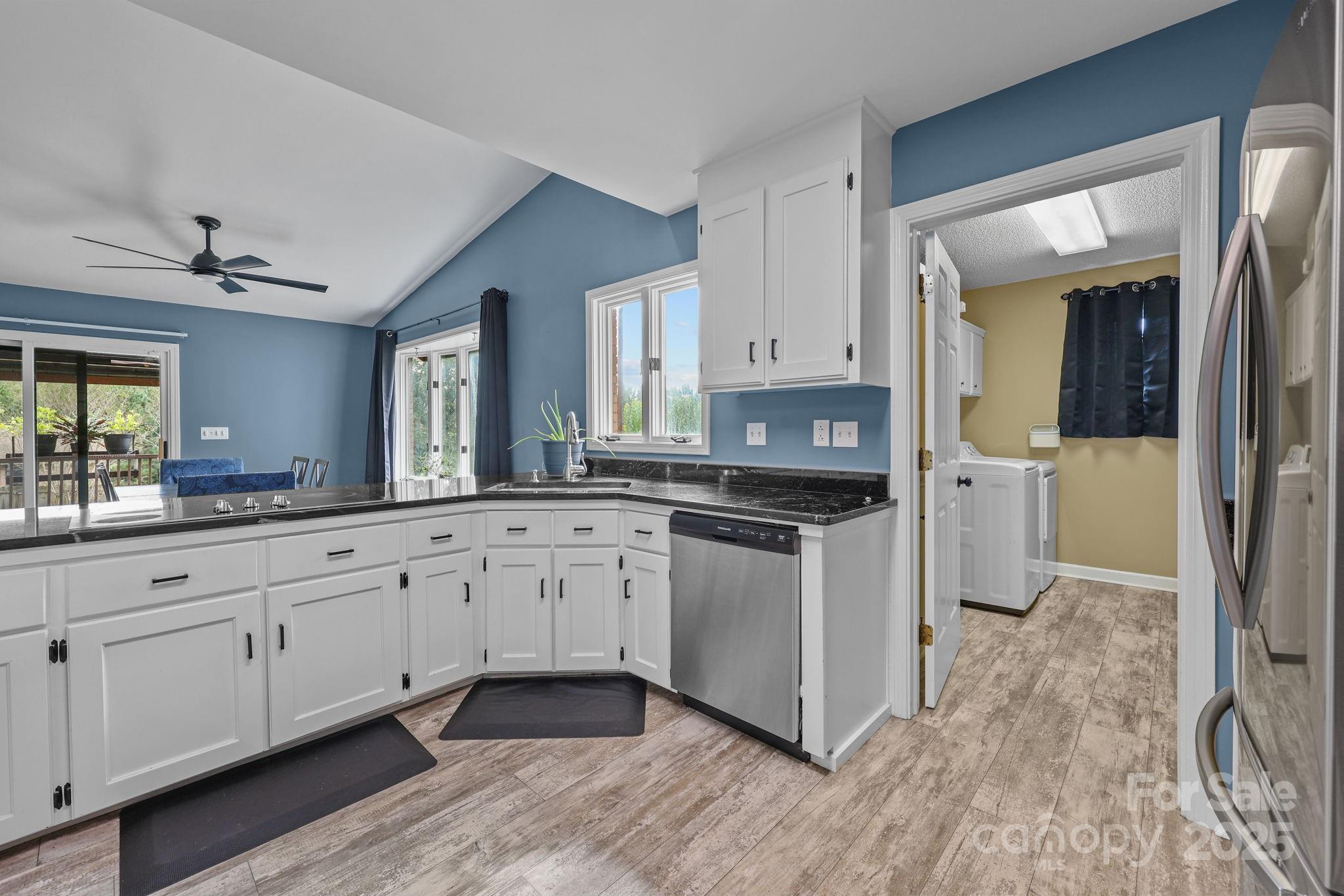 1765 Liberty Road Gold Hill, NC 28071 - Photo 6 of 41 a kitchen with granite countertop white cabinets and white appliances