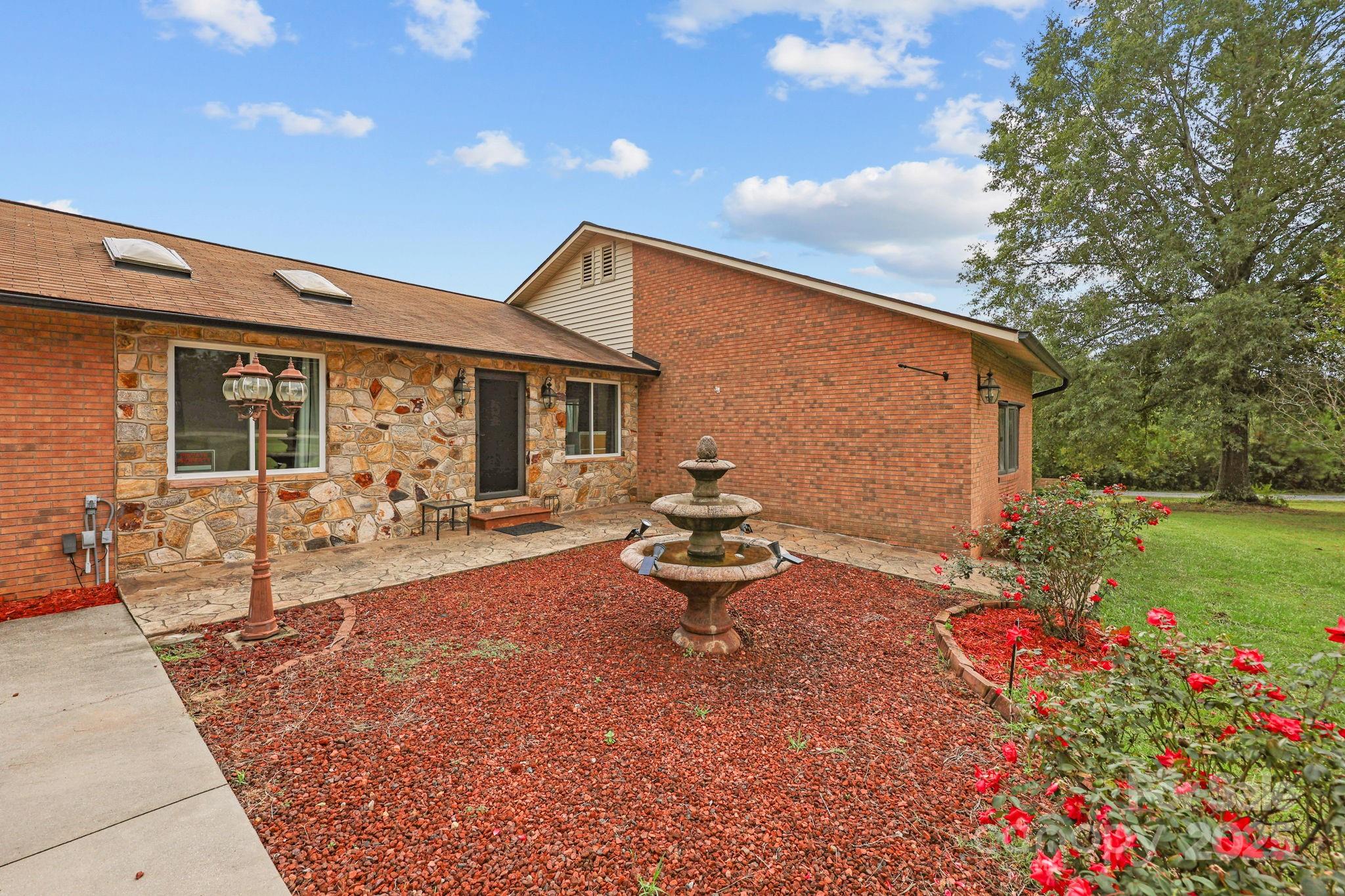 1765 Liberty Road Gold Hill, NC 28071 - Photo 7 of 41 a backyard of a house with table and chairs