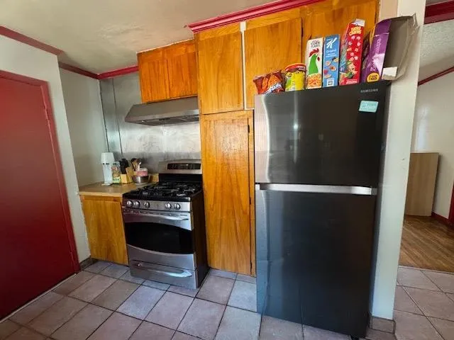 a kitchen with a refrigerator and a stove