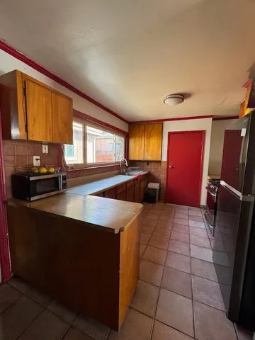 a kitchen with stainless steel appliances a sink a stove cabinets and a counter top space