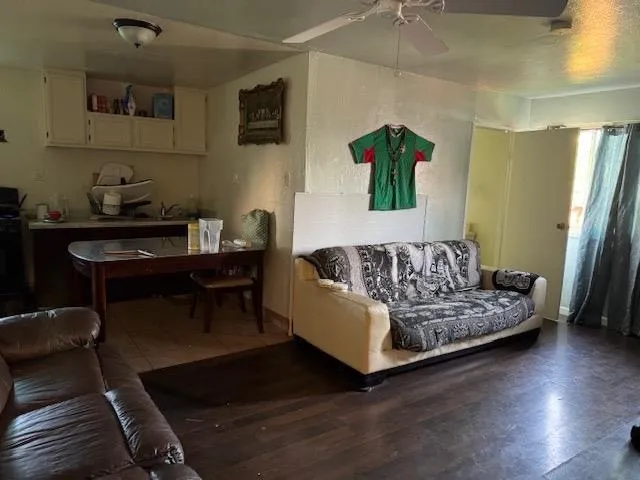 a living room with furniture and wooden floor