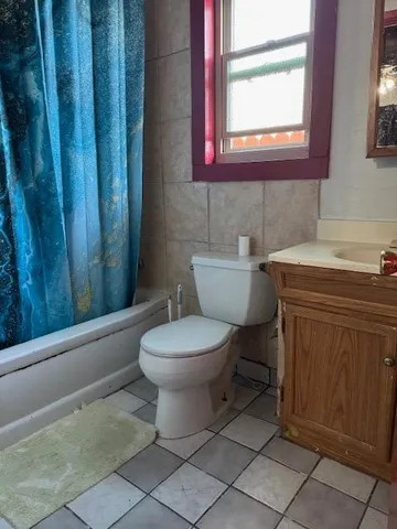 a bathroom with a toilet a sink and a window