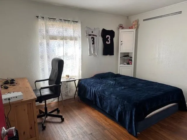 a bedroom with a bed and a window