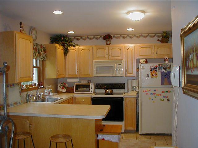 2203 Brislin Road Stroudsburg, PA 18360 - Photo 4 of 11 a kitchen with stainless steel appliances a refrigerator a sink a stove and white cabinets
