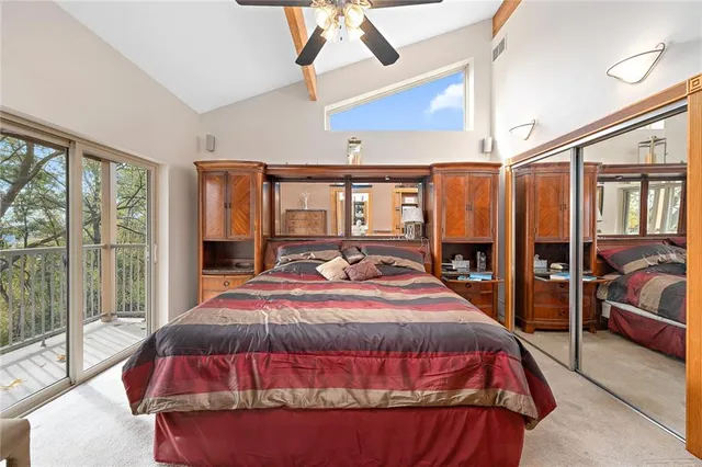 a bedroom with a large bed and a balcony