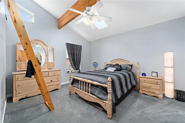 a spacious bedroom with a bed and a chandelier