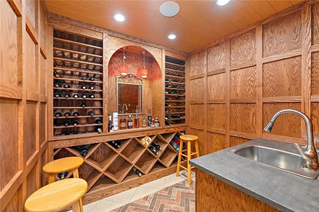 a kitchen with a sink and a black refrigerator