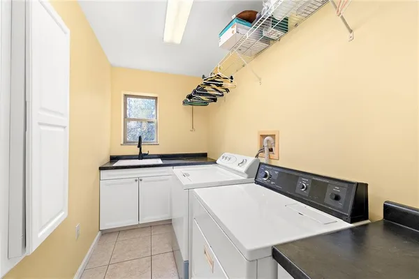 a room with a sink and cabinets