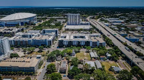an aerial view of a house with yard table and chairs under an umbrella