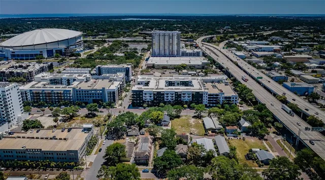 an aerial view of a house with yard table and chairs under an umbrella