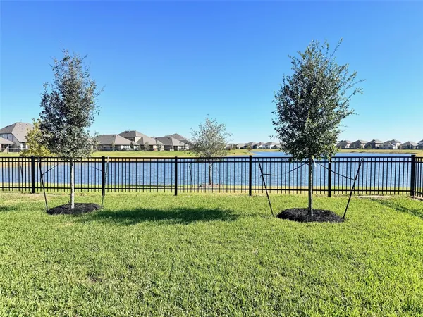 a view of a swimming pool and a yard