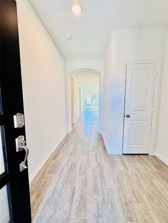 wooden floor in a hall with an empty room