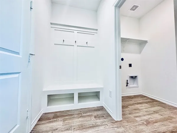 a view of kitchen with wooden floor and electronic appliances