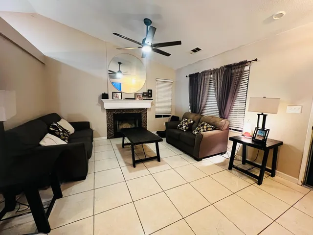 a living room with furniture and a fireplace
