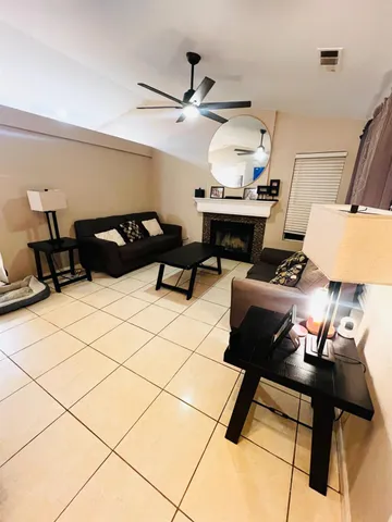 a living room with furniture and a piano