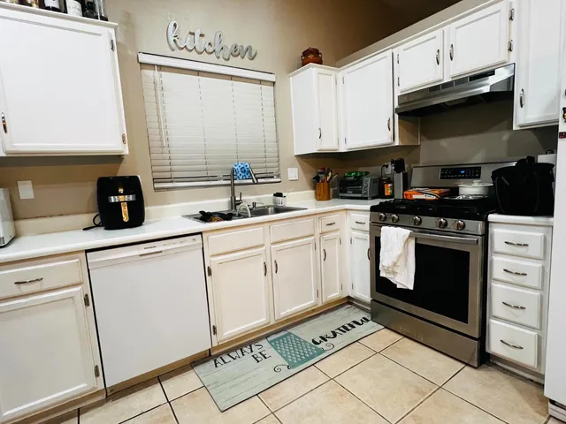 a kitchen with appliances cabinets and a sink