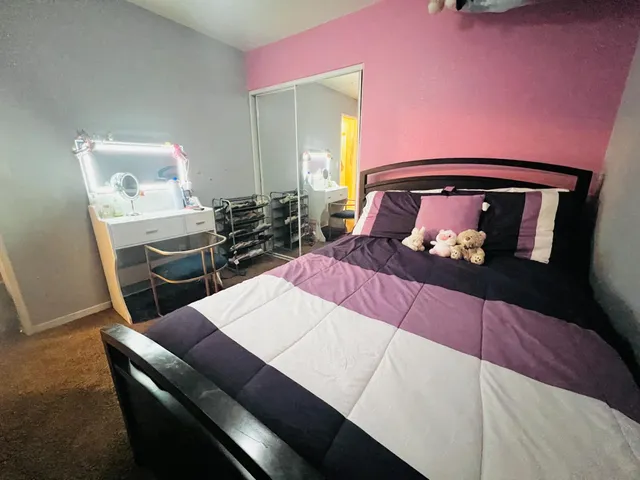 a bedroom with a bed and a dresser