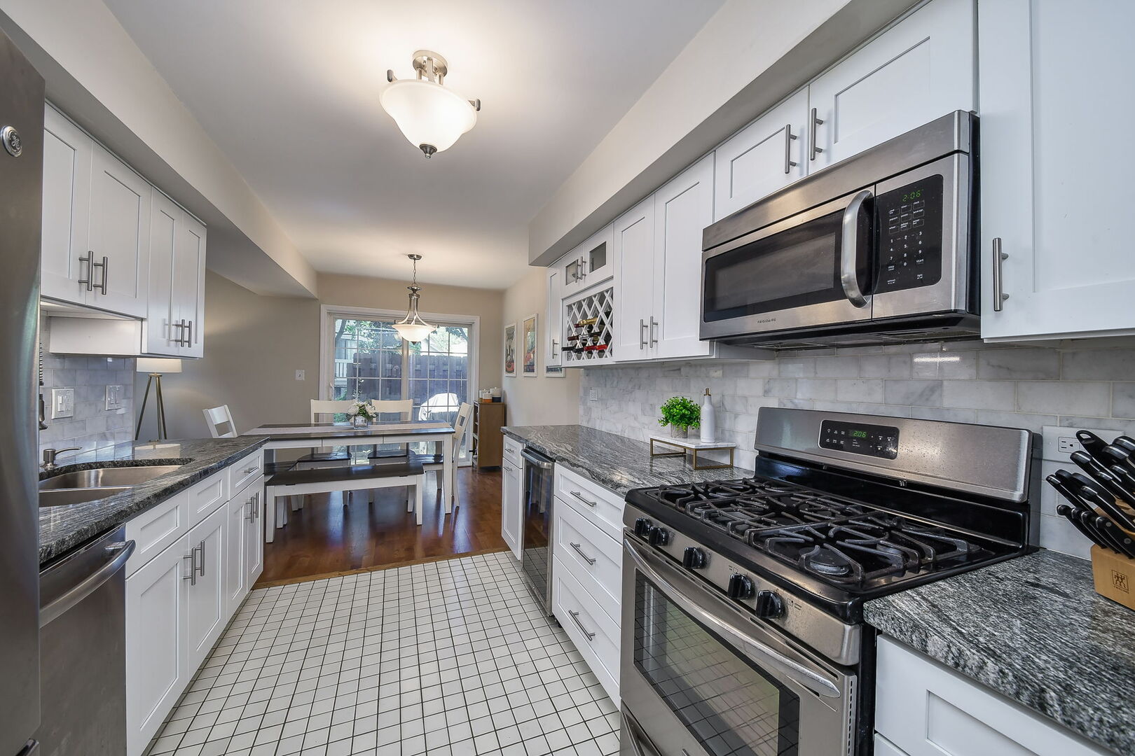 1941 Gresham Circle Wheaton, IL 60189 - Photo 4 of 13 a kitchen with stainless steel appliances granite countertop a stove top oven a sink dishwasher and a microwave oven with the cabinets
