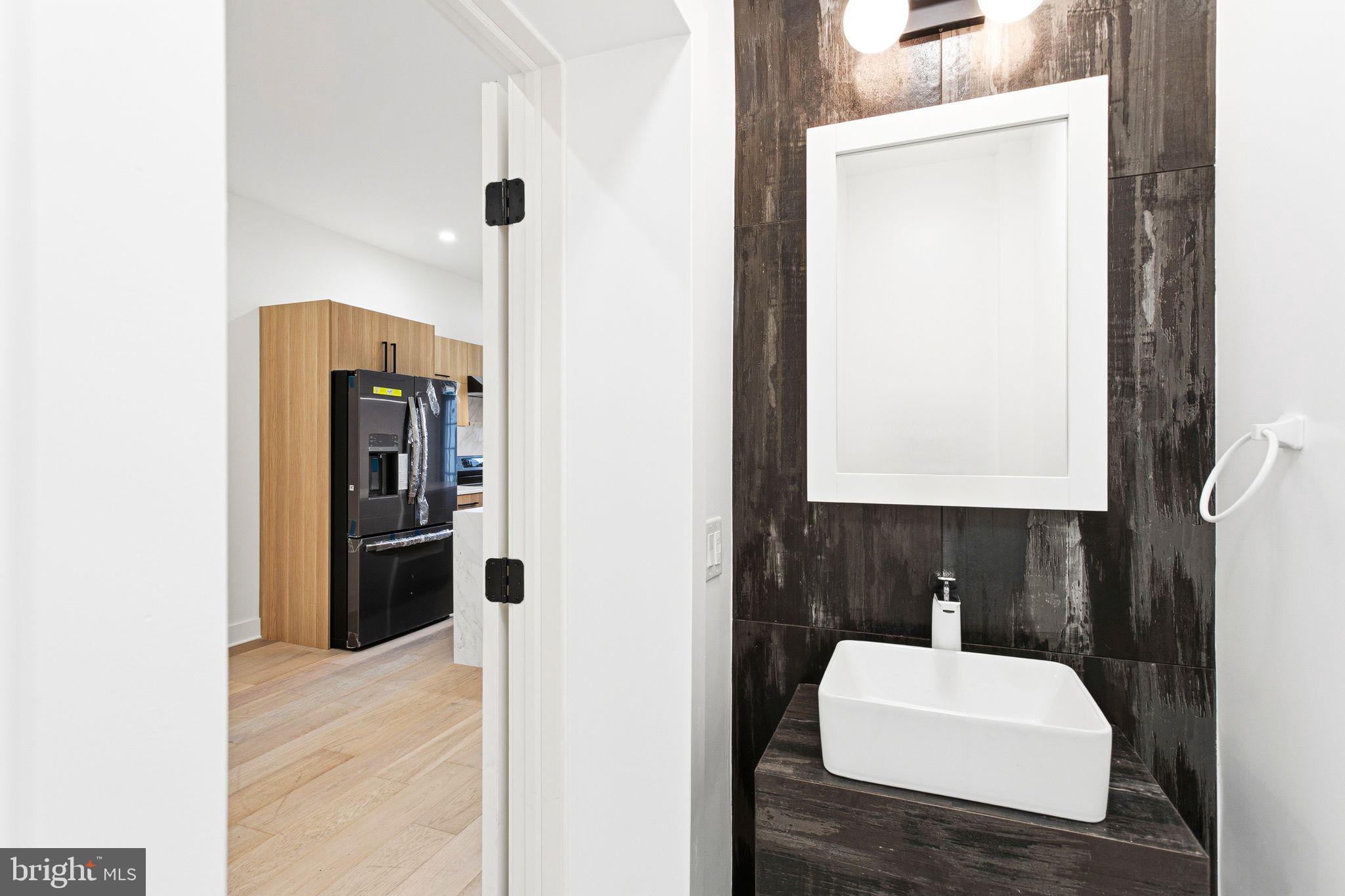 1419 Wharton Street Philadelphia, PA 19146 - Photo 11 of 39 a bathroom with a sink and a mirror