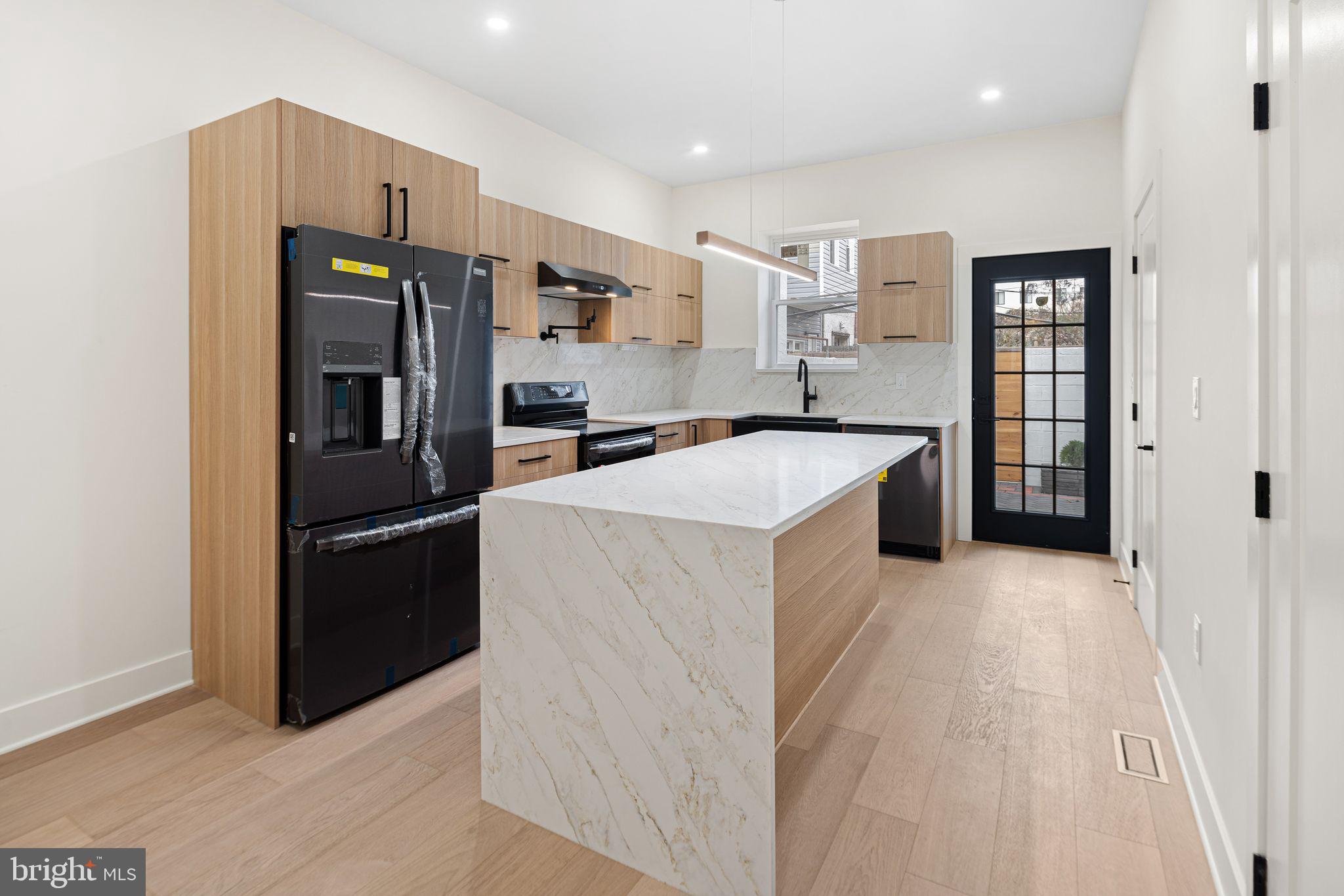 1419 Wharton Street Philadelphia, PA 19146 - Photo 5 of 39 a kitchen with stainless steel appliances a refrigerator and a stove