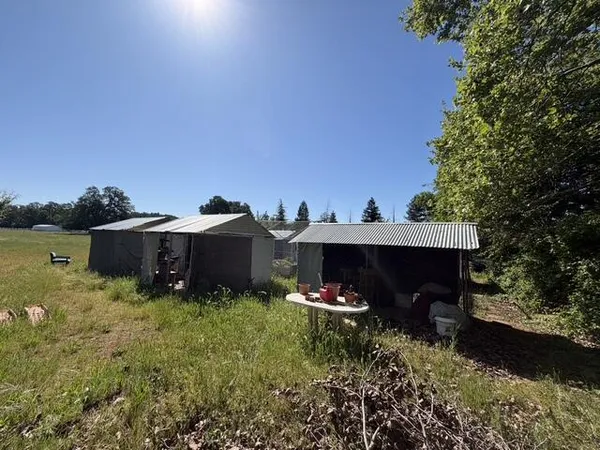 a view of a house with a yard and a garden
