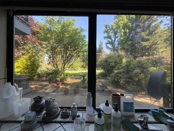 a kitchen with stainless steel appliances granite countertop a stove a sink dishwasher and cabinets with wooden floor