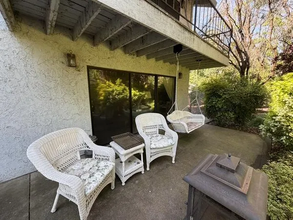 a balcony with table and chairs