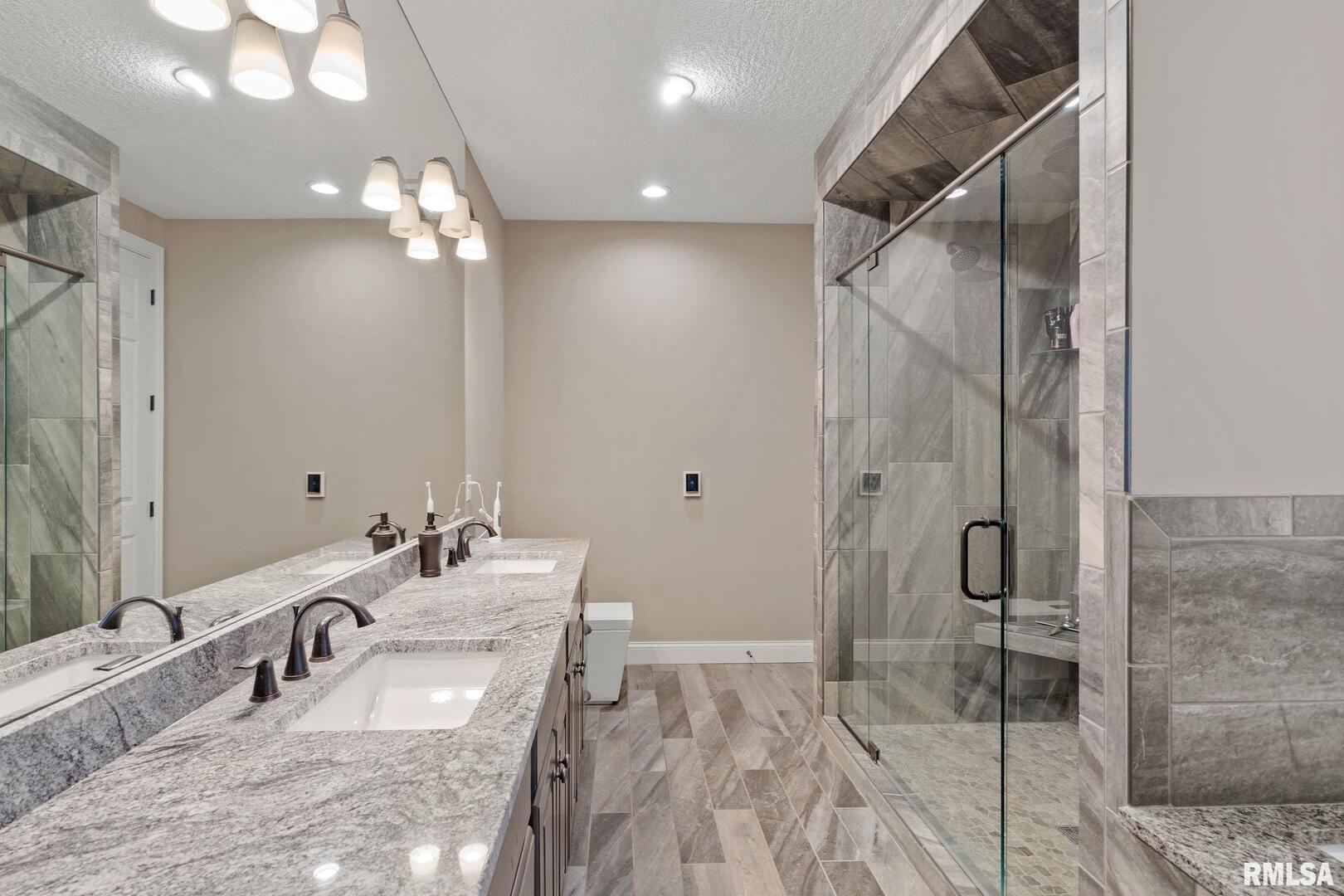 1422 Racine Court Davenport, IA 52804 - Photo 21 of 53 a bathroom with a double vanity sink mirror and shower