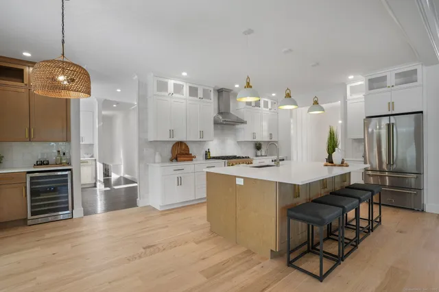 a view of a living room kitchen with furniture and wooden floor