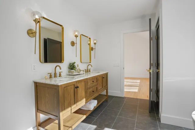 a white bath tub sitting in a bathroom next to a window