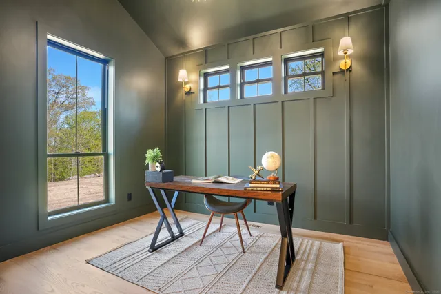a view of a dining room with furniture and chandelier