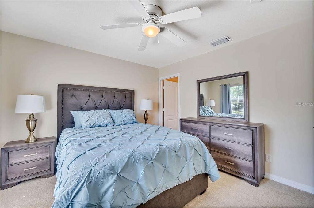 280 Cape Harbour Loop, Unit 101 Bradenton, FL 34212 - Photo 12 of 35 a bedroom with a bed and a chandelier