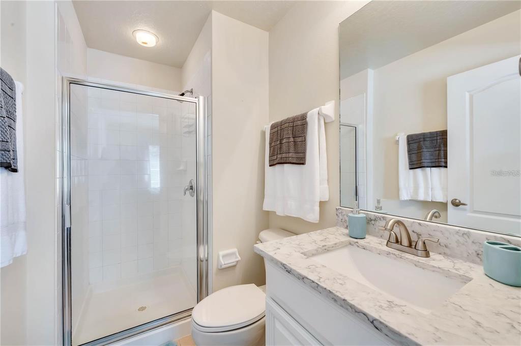 280 Cape Harbour Loop, Unit 101 Bradenton, FL 34212 - Photo 14 of 35 a bathroom with a granite countertop sink toilet and shower