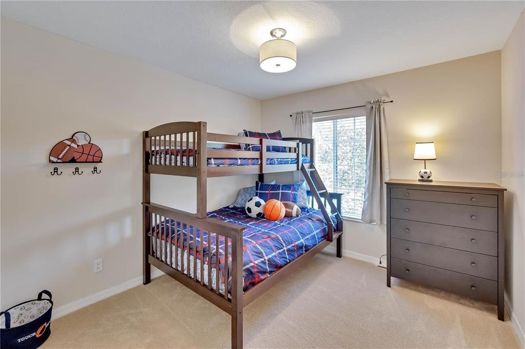 280 Cape Harbour Loop, Unit 101 Bradenton, FL 34212 - Photo 15 of 35 a bedroom with a bed and a chandelier