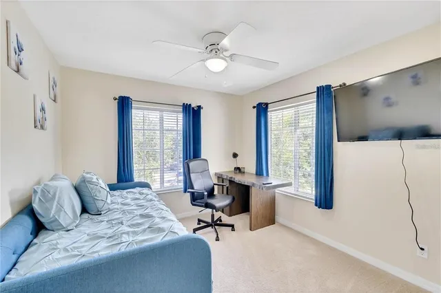 a living room with furniture and large windows